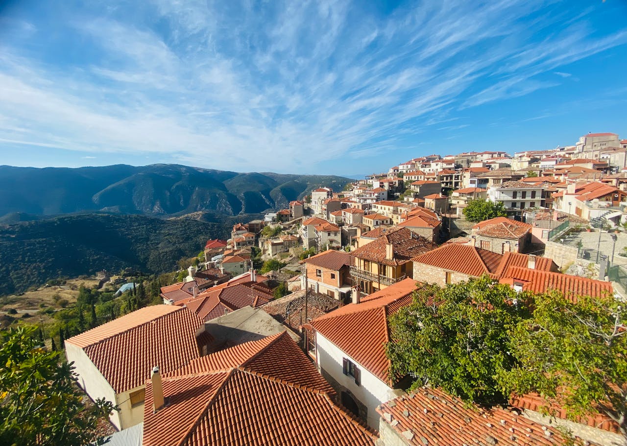 Discover a charming Mediterranean village with red-tiled roofs nestled in the mountains.