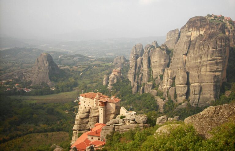 Stunning aerial view of Meteora's ancient monasteries atop rock formations in Greece.