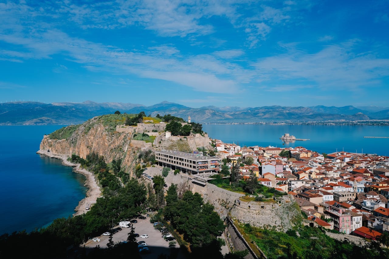 Aerial view of Nafplio, Greece, showcasing a historic fortress and vibrant seascape.
